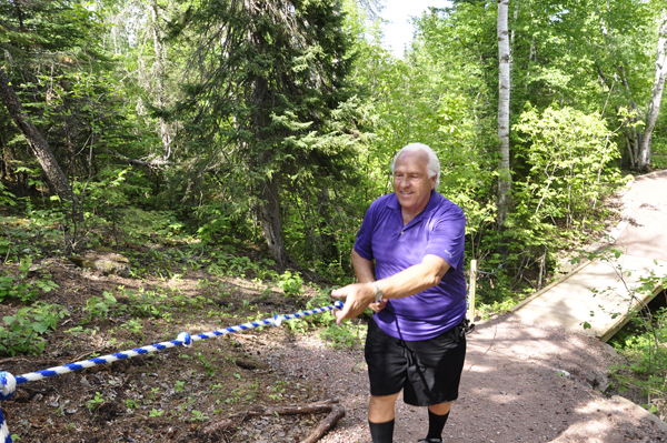 Lee Duquette using the rope to get up a steep hill